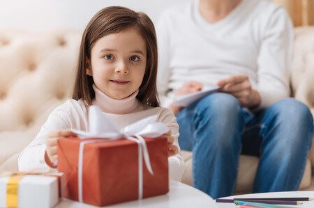 Little girl with present. Children of divorce. Kid